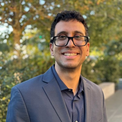 Headshot of Shahin Saberi in front of trees
